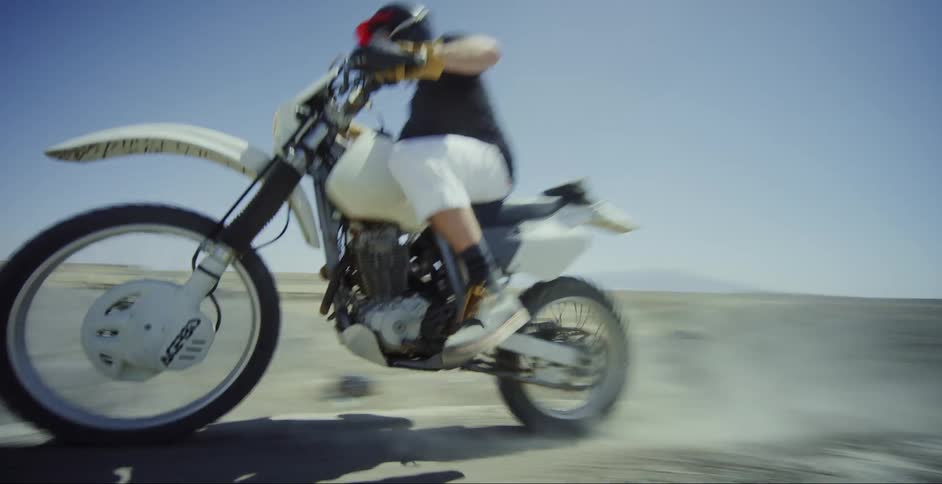 Man riding a motocross bike in a natural environment on the ground