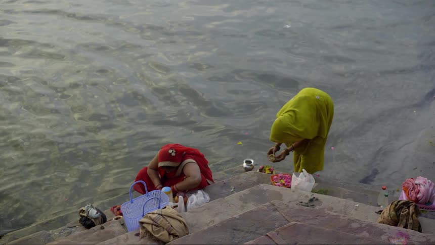 Two women by the seaside wearing burqas