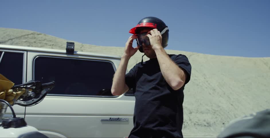 Man putting on a motorcycle helmet