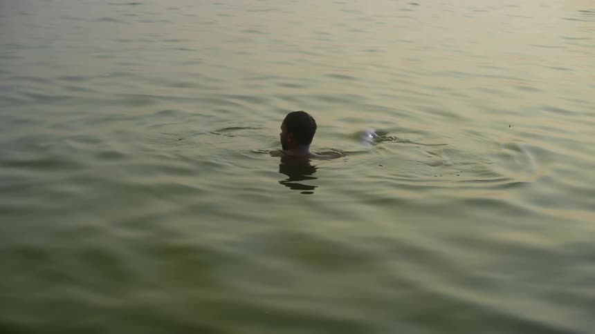 Man submerged in the water with his head above the surface