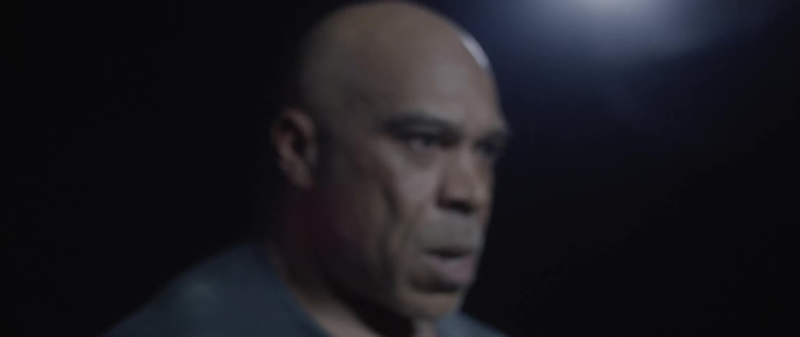 Portrait of a man in a darkroom exhaling deeply