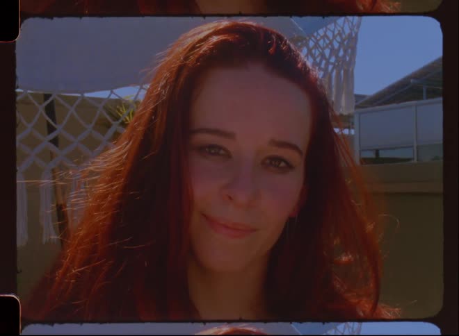 Portrait of a redhead woman with a slight smile