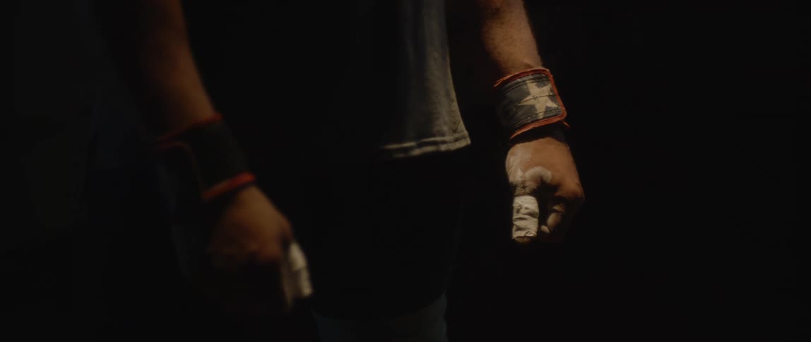 Hands closed with white tape on the fingers