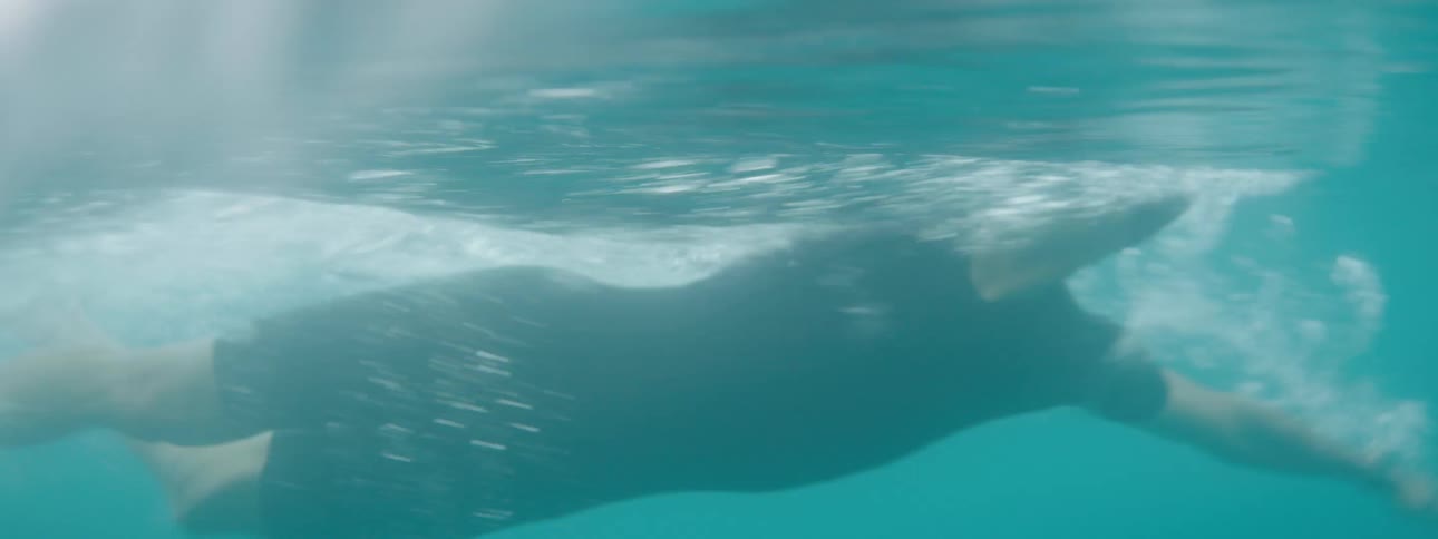 A clip of a man swimming the sea wave