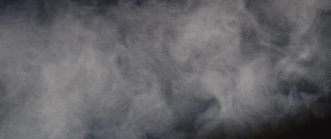 A cloud of smoke particles moves in the air