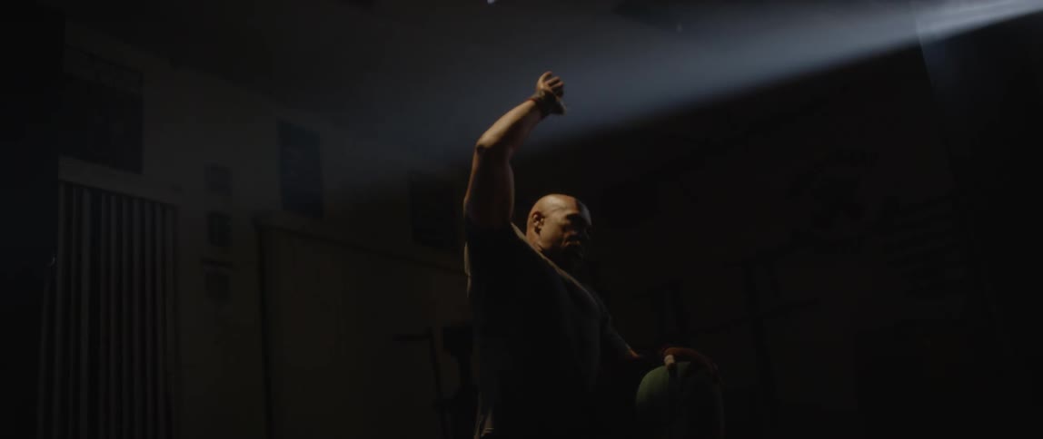 A clip of a man exercising in the dark room