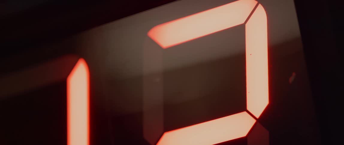 A digital clock displaying numbers counting down ticking away the seconds