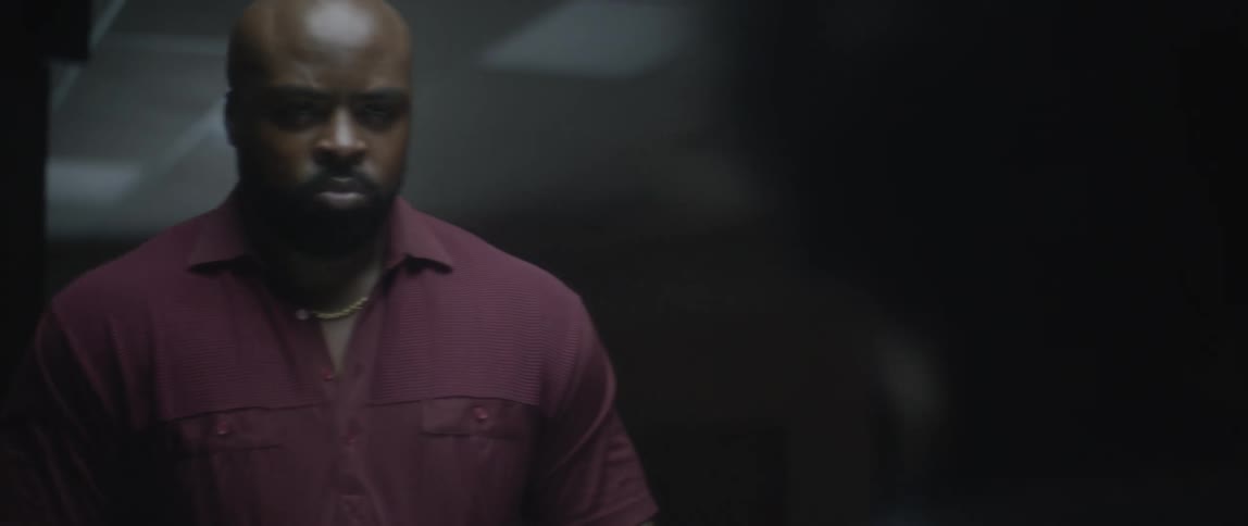 Man with a serious expression looking at a boy