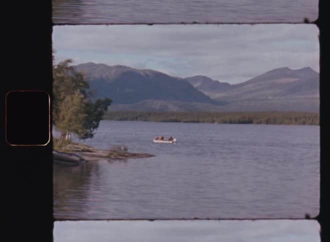 Panorama of a lake in the midst of a natural environment with a chain of mountains on the horizon