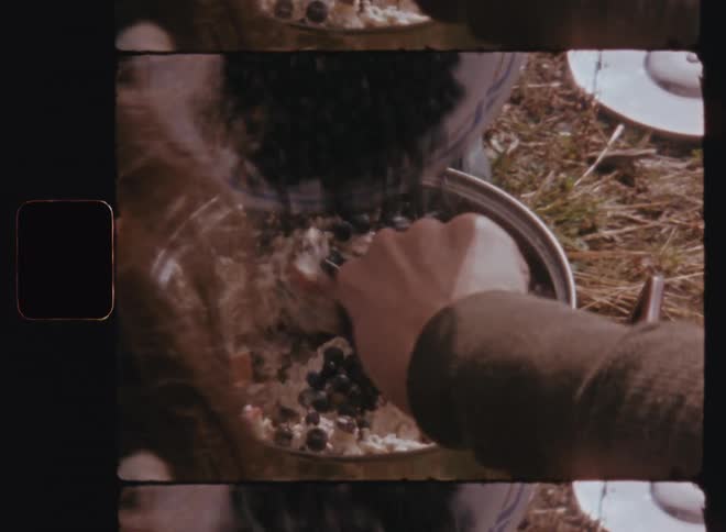Grains being placed into a pot with food being cooked without a fire