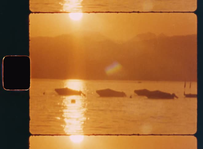 Boats anchored at sea during sunset