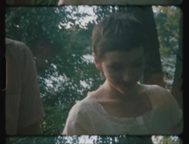 Man and woman holding hands happily walk in the forest