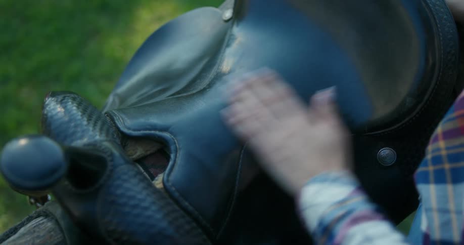 A woman rubbing her hand on a leather