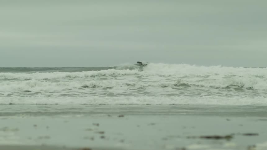 A person is surfing a wave in the ocean