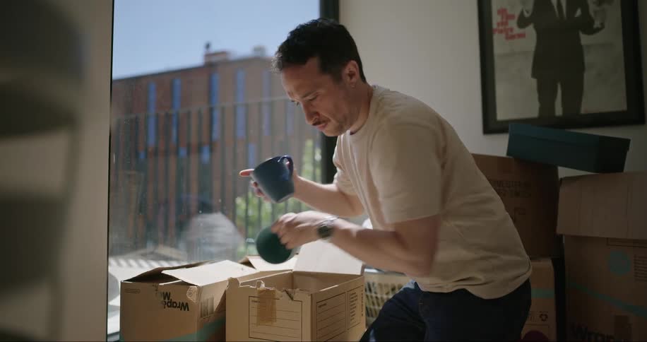 A man taking utensils out of a box
