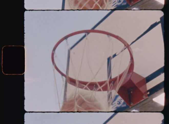 A ball passing through the net of a basketball hoop