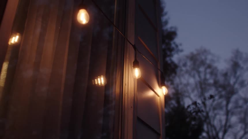 Lightbulbs on the outside of a house at evening