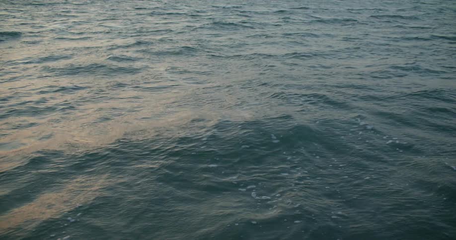 Seawater with small waves during sunset
