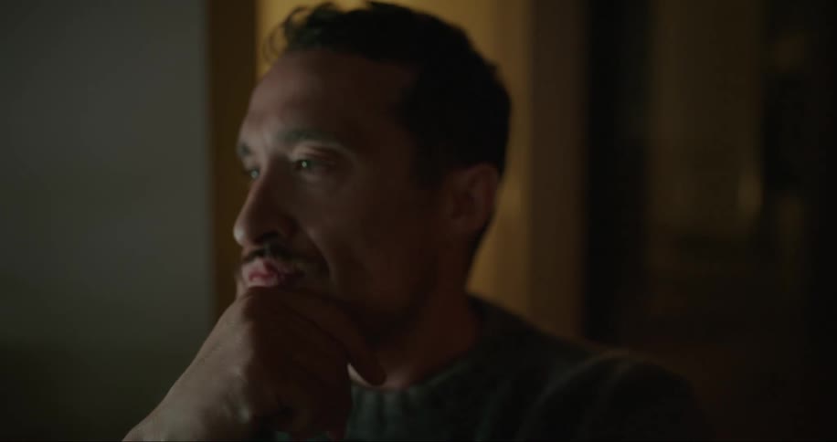 A man brings his hand to his face in thoughtful tones