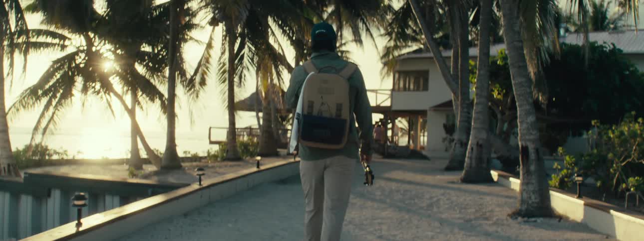 A man walking towards the beach house