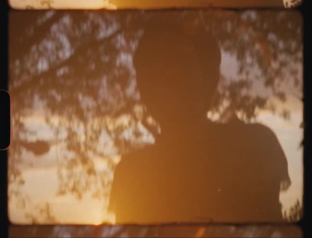 Man spoonfeed a lady while on a picnic at sunset