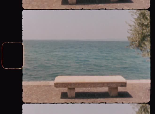 A concrete bench at the edge of the sea on a hot summer day