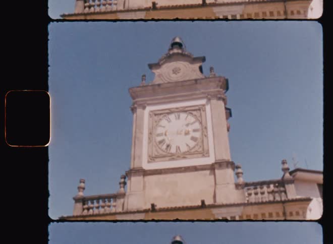 View of a church tower with a clock against a blue sky