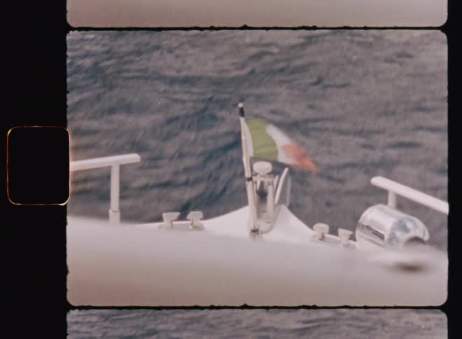 Flag waving in the wind on the bow of a yacht