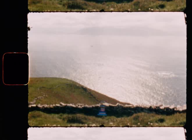 Mountainous ocean coast during hot day