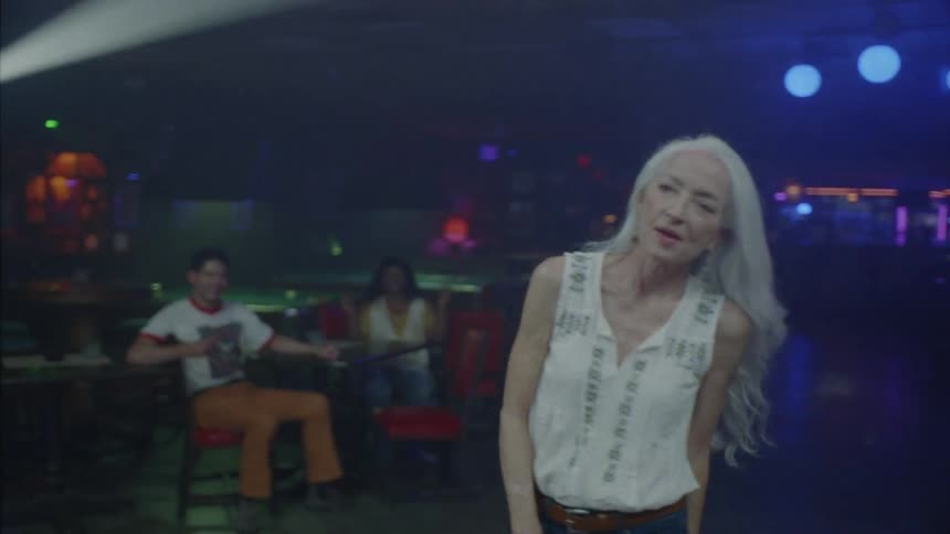 A woman dancing while a band plays at the party