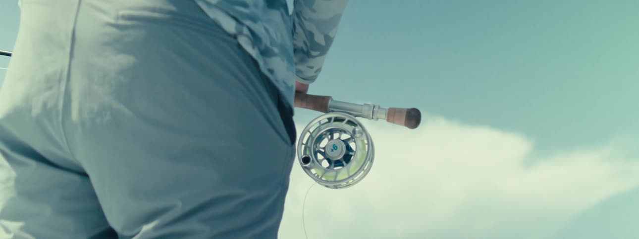 A person holding a fishing rod outdoors