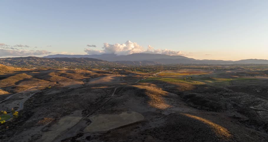 An aerial view of a rural region with small earthen hills