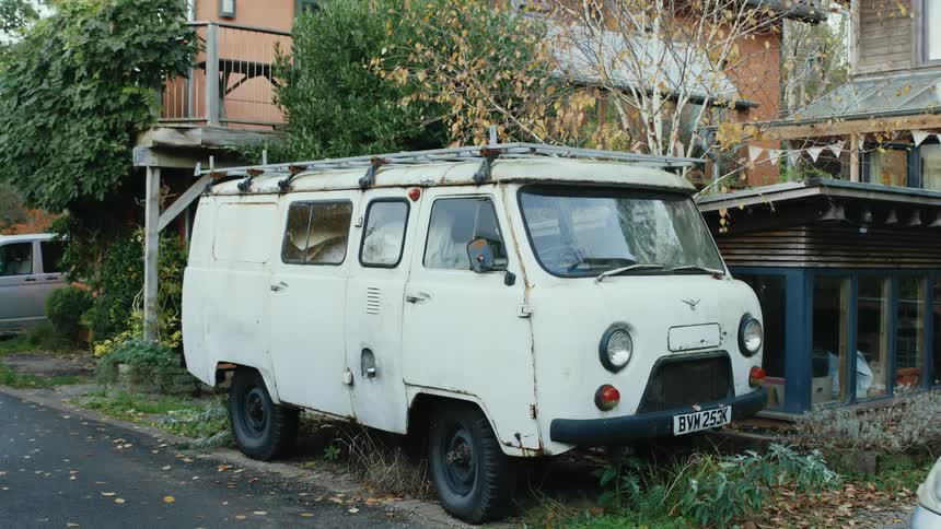 A van parked in front of a house in the suburbs