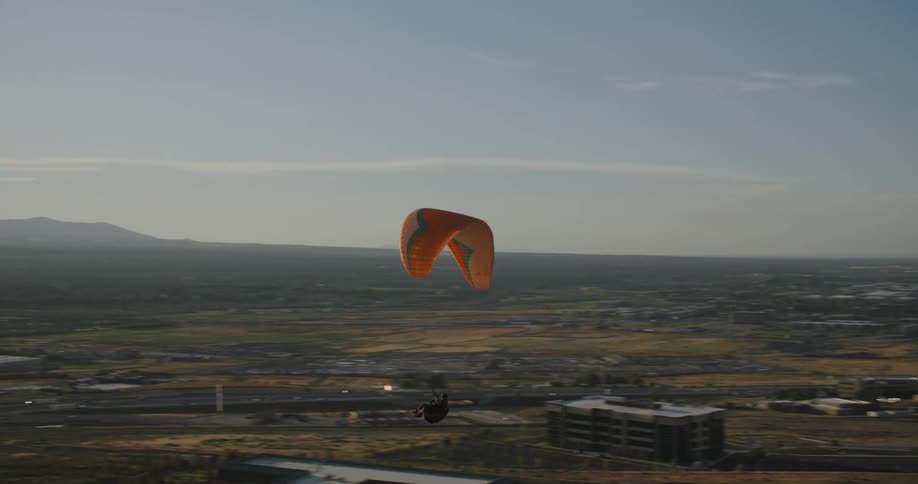 A person parachuting in a small town