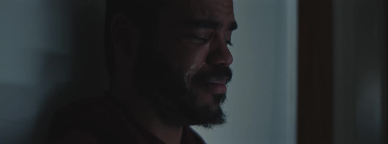 Close up of man with a beard weeping