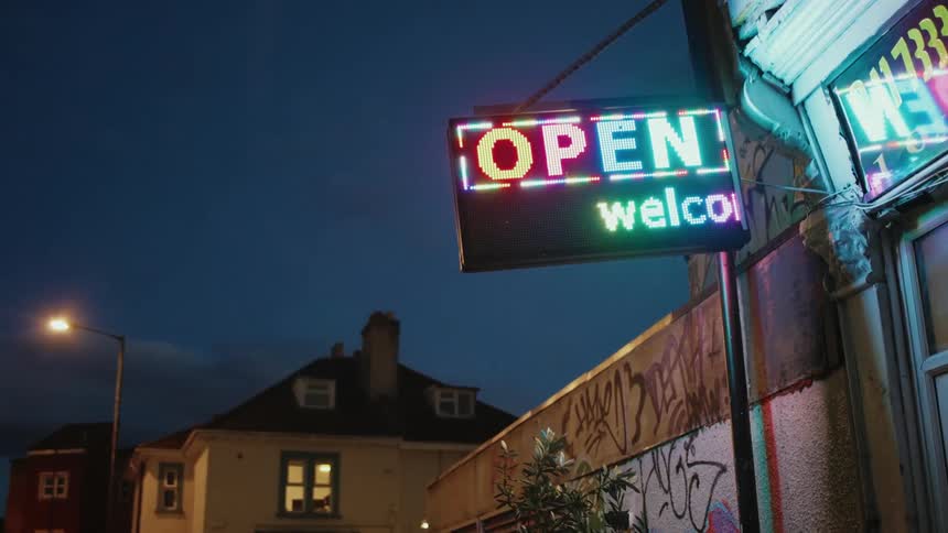 Neon sign outside a street store at night