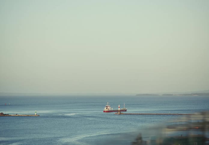 View of the sea with a cargo ship in motion