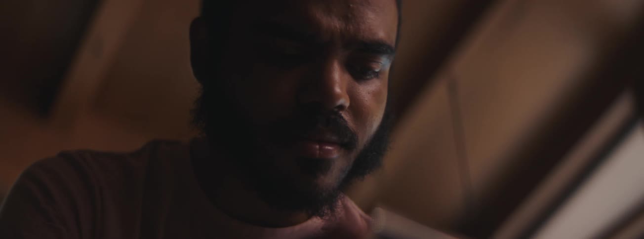 A sad man looking at a photograph