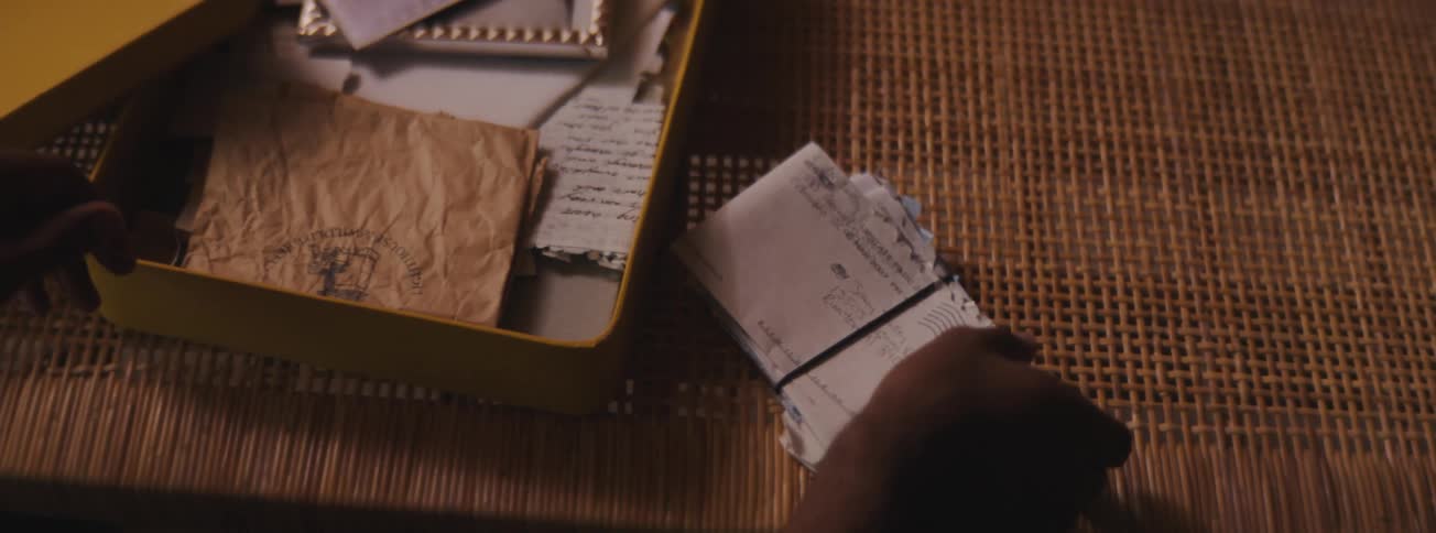 A man opening a memory box with old photos and letters