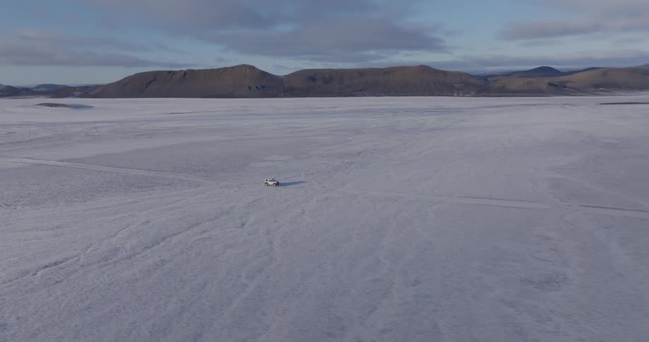 A car driving across a desert plain