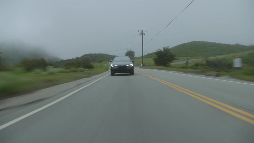 Car driving on a road through the countryside