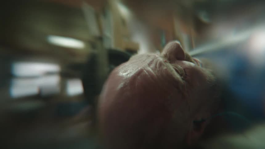 Portrait of a man lying down doing bench presses with extreme force