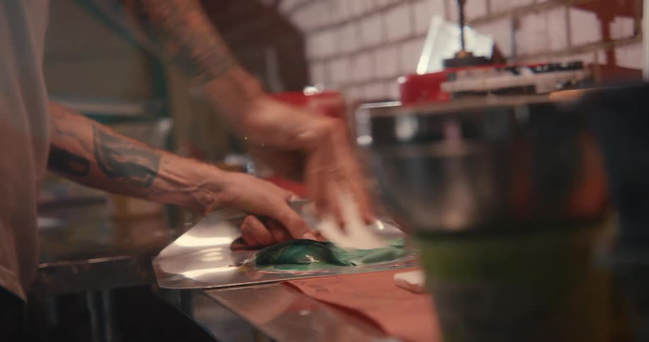 A man is mixing paint on the counter