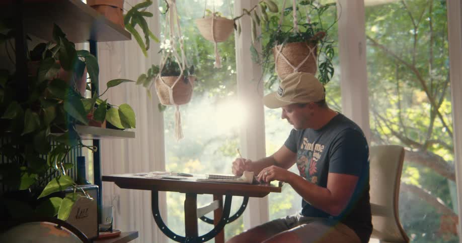 A man is writing at home