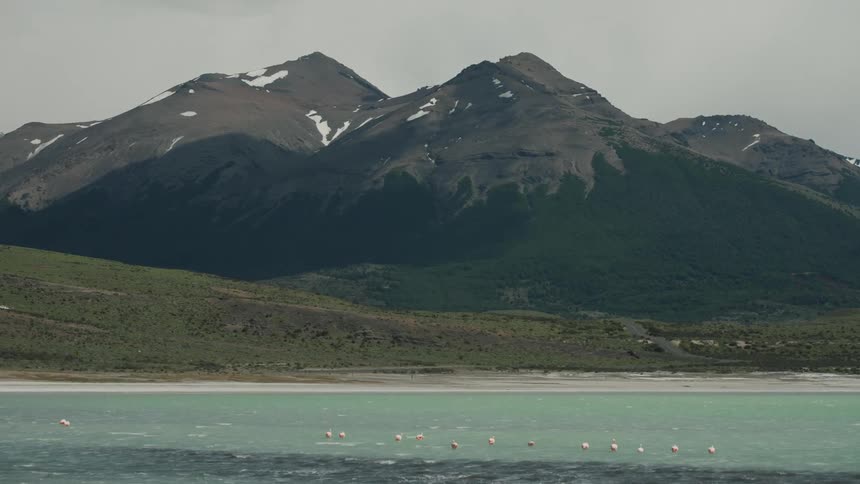 Beach coasted with mountains and plains in the background