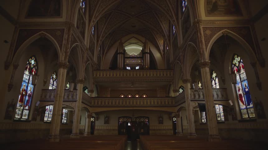 The interior of the catholic church with art in the stainedglass windows
