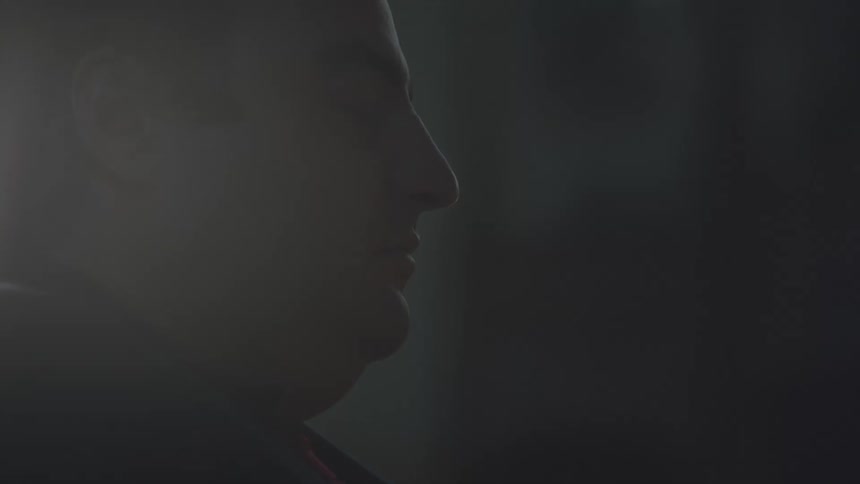 A man praying in a dark church