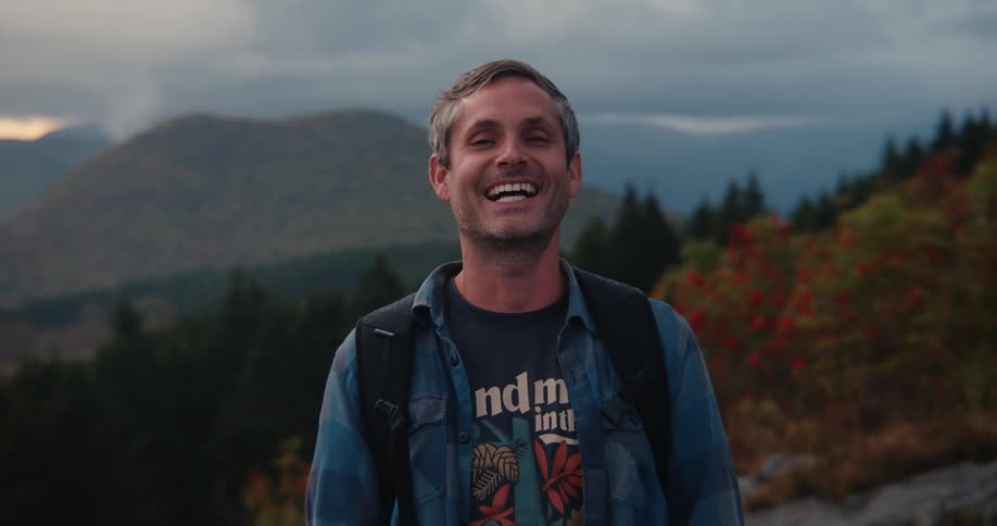 A hiker is laughing on the hill