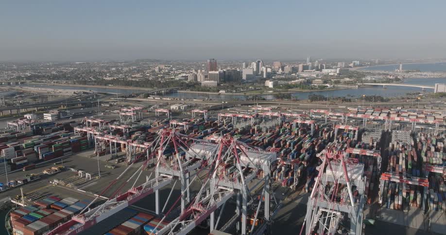 A sea port with lots of cranes and containers