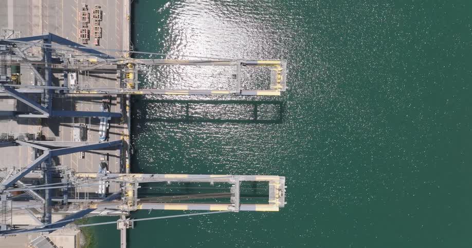 Aerial panorama of cranes in a seaside port of a logistics center